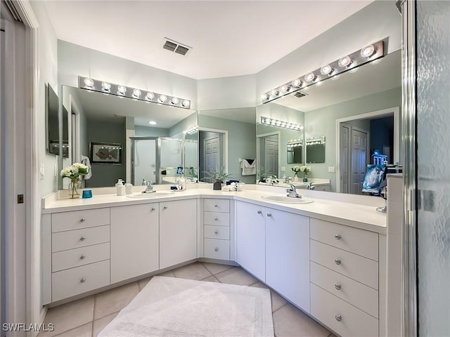 14641 Glen Cove Dr Unit 1704, Fort Myers, FL 33919 - full bathroom with a sink, a shower stall, tile patterned flooring, visible vents, and double vanity
