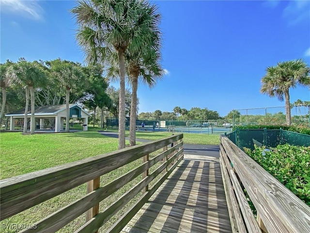 14641 Glen Cove Dr Unit 1704, Fort Myers, FL 33919 - view of community with a tennis court, fence, and a yard