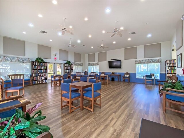 14641 Glen Cove Dr Unit 1704, Fort Myers, FL 33919 - living room featuring ceiling fan, a towering ceiling, visible vents, and wood finished floors
