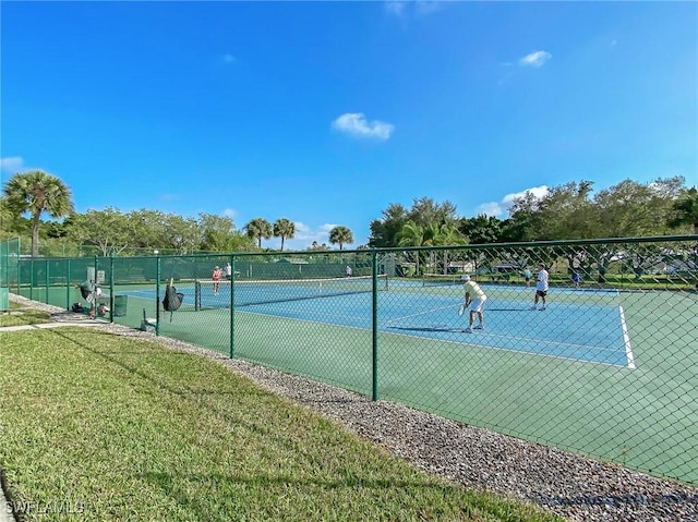 14641 Glen Cove Dr Unit 1704, Fort Myers, FL 33919 - view of tennis court featuring fence and a yard