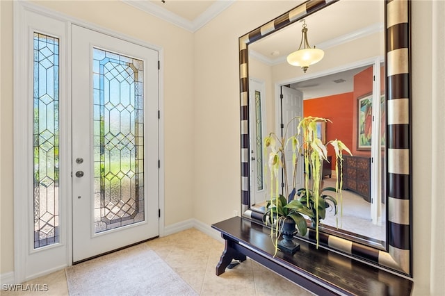 tiled entrance foyer with baseboards and ornamental molding