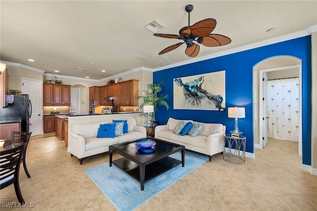 living room with arched walkways, light tile patterned floors, visible vents, and a ceiling fan