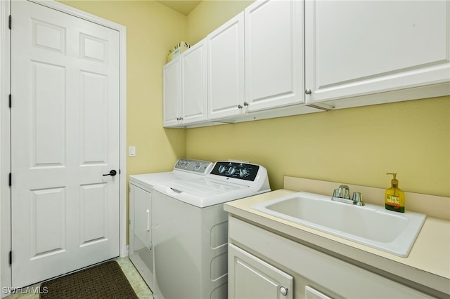 laundry room with a sink, cabinet space, and washing machine and dryer