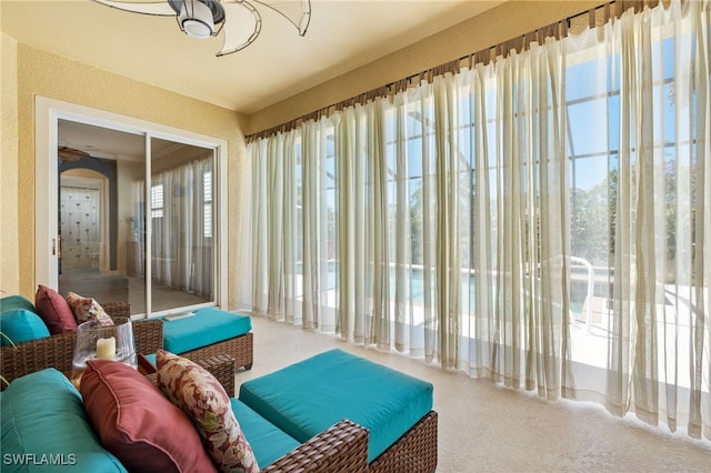 sitting room with a textured wall and carpet