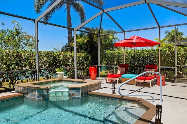 view of pool featuring a patio area, a pool with connected hot tub, and glass enclosure