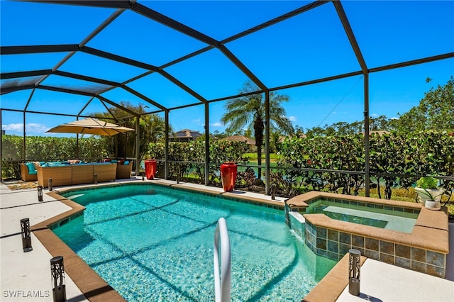 pool featuring outdoor lounge area, a patio area, an outdoor hot tub, and glass enclosure