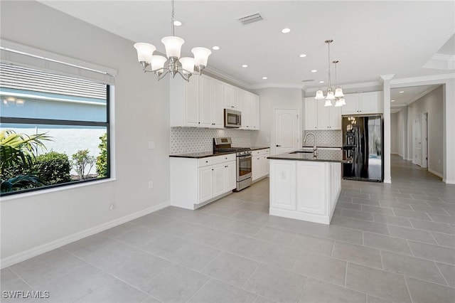 kitchen featuring crown molding, dark countertops, a chandelier, stainless steel appliances, and backsplash