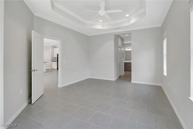 2967 Amblewind Dr, Fort Myers, FL 33905 - tiled spare room featuring a ceiling fan, a tray ceiling, ornamental molding, recessed lighting, and baseboards
