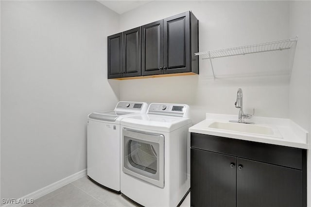 2967 Amblewind Dr, Fort Myers, FL 33905 - laundry room featuring cabinet space, independent washer and dryer, baseboards, and light tile patterned floors