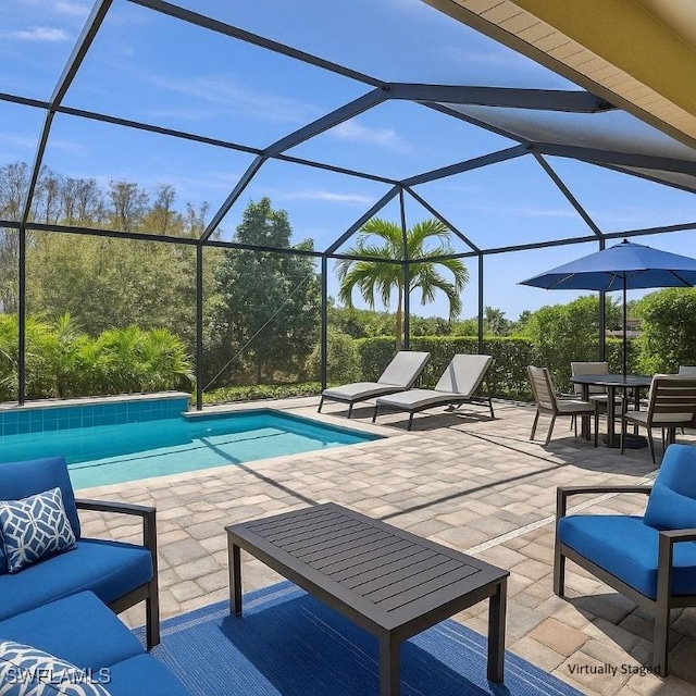 2967 Amblewind Dr, Fort Myers, FL 33905 - swimming pool featuring a patio area, glass enclosure, and outdoor dining space