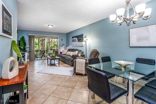 1702 Kings Lake Blvd Unit 103, Naples, FL 34112 - dining room with a chandelier, a textured ceiling, and light tile patterned floors