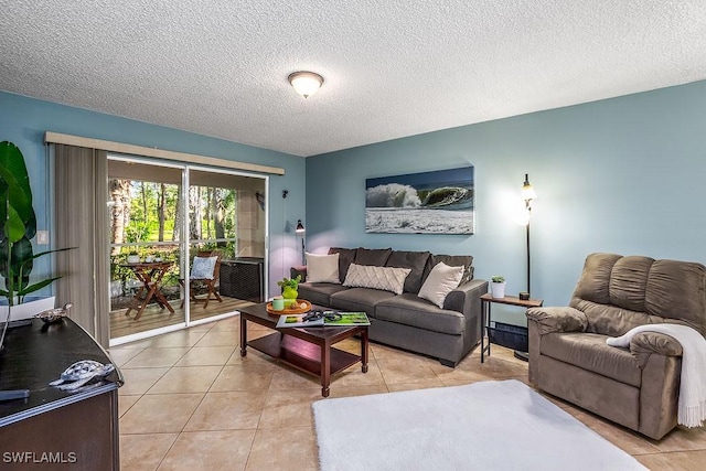1702 Kings Lake Blvd Unit 103, Naples, FL 34112 - living room featuring a textured ceiling and light tile patterned floors