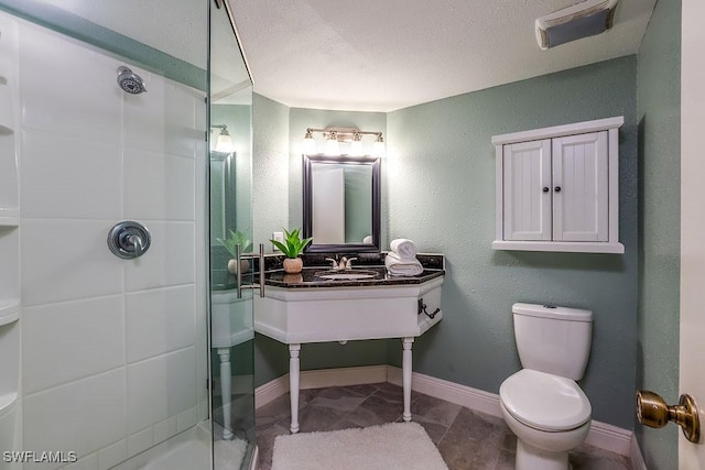 1702 Kings Lake Blvd Unit 103, Naples, FL 34112 - full bathroom with a shower stall, a sink, toilet, baseboards, and a textured ceiling