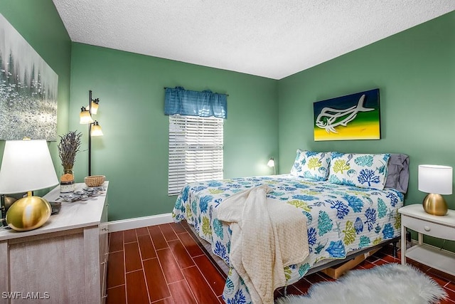 1702 Kings Lake Blvd Unit 103, Naples, FL 34112 - bedroom with baseboards, wood finish floors, and a textured ceiling