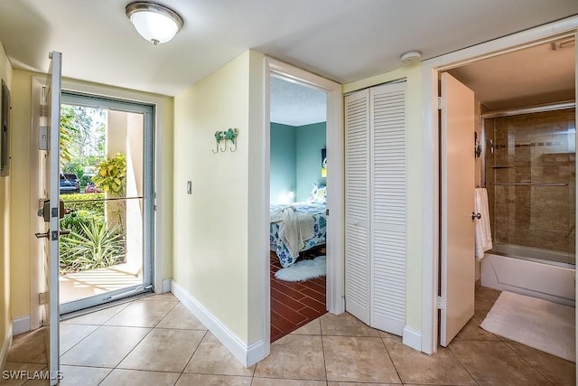 1702 Kings Lake Blvd Unit 103, Naples, FL 34112 - foyer with light tile patterned flooring and baseboards