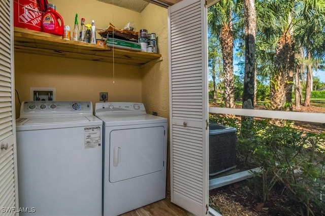1702 Kings Lake Blvd Unit 103, Naples, FL 34112 - laundry area with washing machine and dryer and wood finished floors