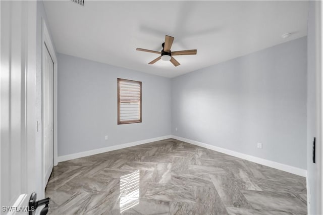 unfurnished bedroom with baseboards, a ceiling fan, and a closet