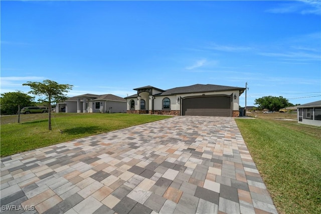 prairie-style home featuring stone siding, decorative driveway, a front yard, an attached garage, and stucco siding