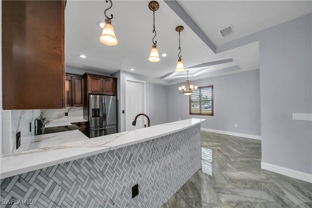 kitchen with a chandelier, stainless steel fridge with ice dispenser, baseboards, visible vents, and a peninsula