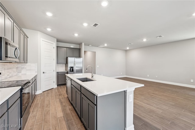 44385 Frontier Dr, Punta Gorda, FL 33982 - kitchen featuring a sink, stainless steel appliances, gray cabinetry, light wood finished floors, and recessed lighting