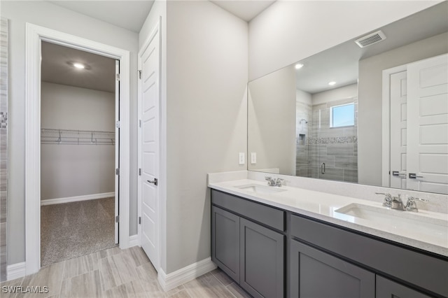44385 Frontier Dr, Punta Gorda, FL 33982 - full bath featuring a stall shower, a walk in closet, double vanity, baseboards, and recessed lighting
