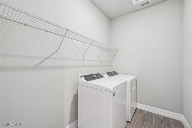44385 Frontier Dr, Punta Gorda, FL 33982 - laundry room with washer and clothes dryer, baseboards, and wood finish floors