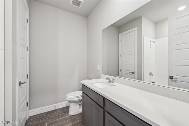 44385 Frontier Dr, Punta Gorda, FL 33982 - bathroom with wood tiled floors, baseboards, toilet, vanity, and recessed lighting