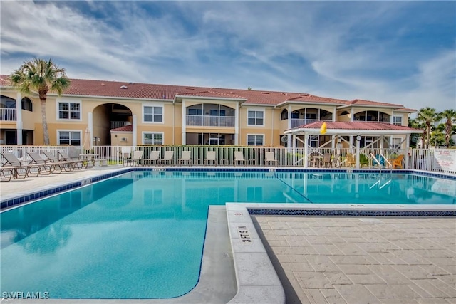 pool featuring a patio area and fence