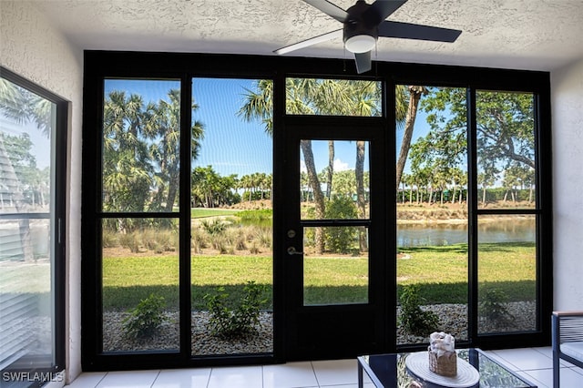 12130 Kelly Greens Blvd Unit 94, Fort Myers, FL 33908 - doorway to outside with a water view, light tile patterned flooring, and a textured ceiling