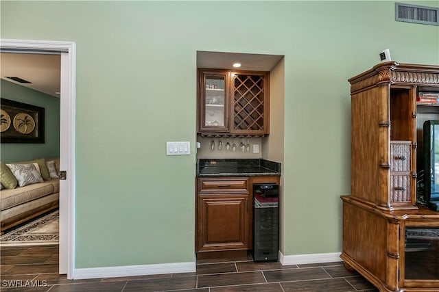 12090 Kelly Greens Blvd Unit 119, Fort Myers, FL 33908 - bar with visible vents, beverage cooler, wood tiled floor, and a dry bar