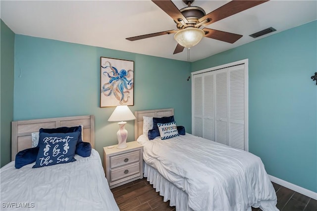 12090 Kelly Greens Blvd Unit 119, Fort Myers, FL 33908 - bedroom with a closet, a ceiling fan, visible vents, wood tiled floor, and baseboards