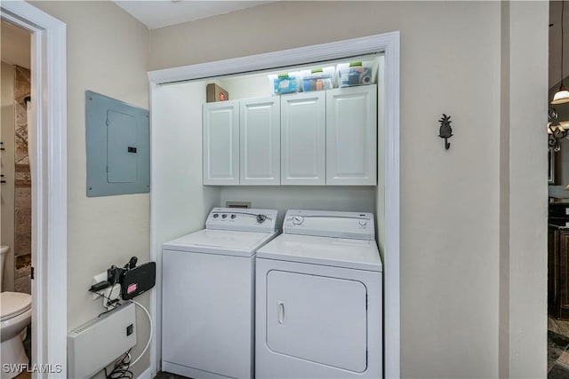 12090 Kelly Greens Blvd Unit 119, Fort Myers, FL 33908 - laundry area with electric panel, washer and clothes dryer, and cabinet space