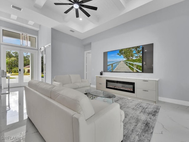 living room featuring a ceiling fan, visible vents, a glass covered fireplace, marble finish floor, and baseboards