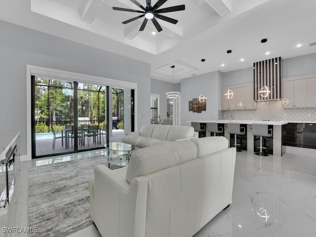 living area with a ceiling fan, beamed ceiling, recessed lighting, marble finish floor, and coffered ceiling