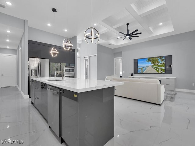 kitchen with modern cabinets, marble finish floor, a sink, coffered ceiling, and baseboards
