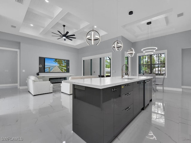 kitchen with a sink, a healthy amount of sunlight, marble finish floor, and modern cabinets