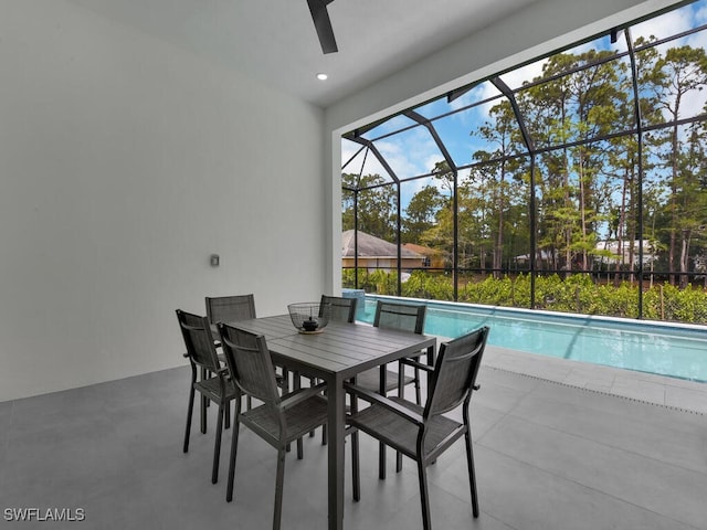 view of patio featuring an outdoor pool, outdoor dining area, and glass enclosure