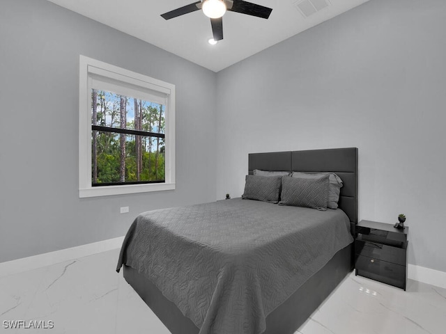 bedroom featuring visible vents, marble finish floor, baseboards, and a ceiling fan