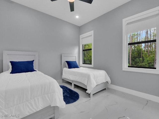 bedroom with recessed lighting, marble finish floor, multiple windows, and baseboards
