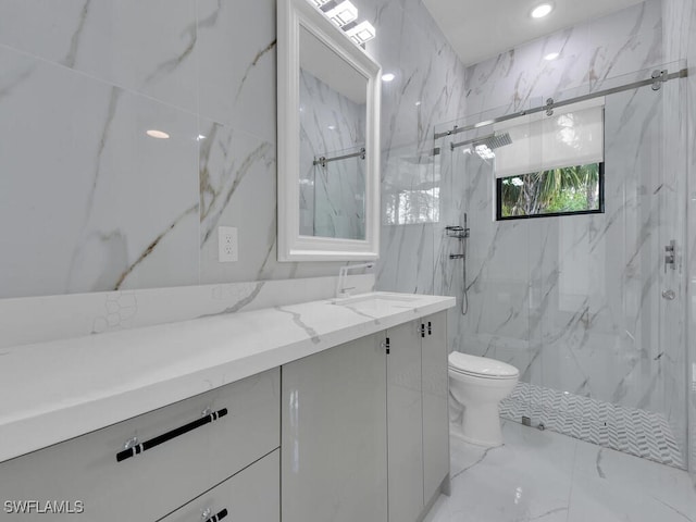 full bath with toilet, marble finish floor, vanity, and a marble finish shower