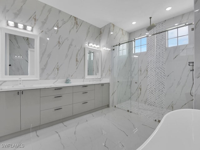 full bathroom with double vanity, marble finish floor, a sink, and a marble finish shower