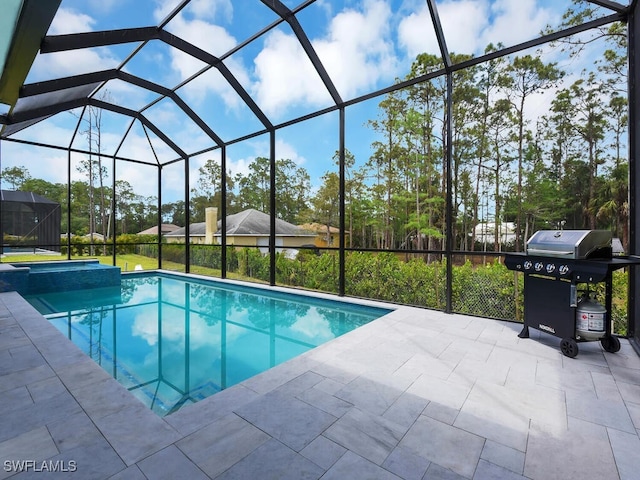 view of pool with a patio area, a pool with connected hot tub, area for grilling, and a lanai