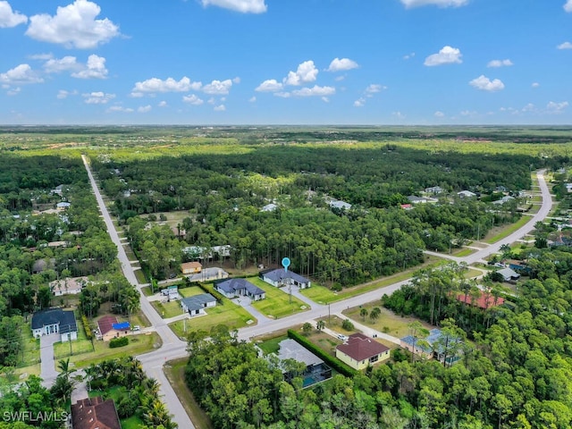 drone / aerial view featuring a forest view