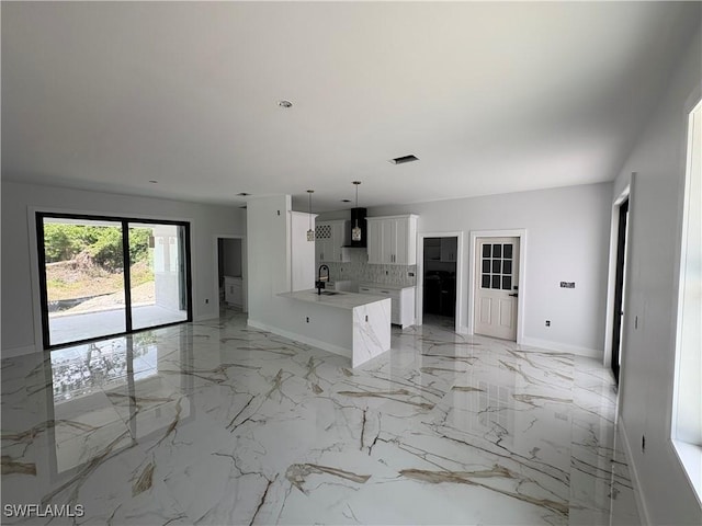 1603 E 5th St, Lehigh Acres, FL 33972 - unfurnished living room featuring baseboards, a sink, and light marble finish flooring