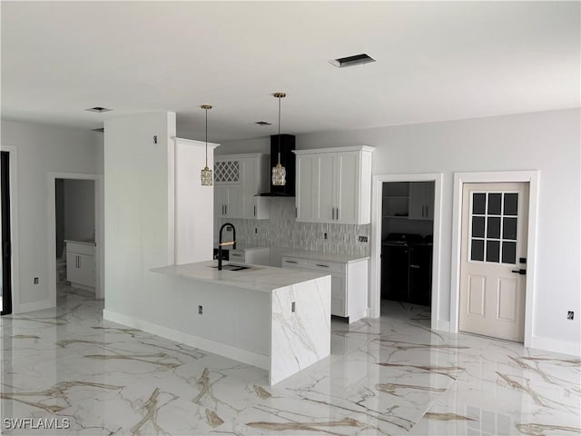 1603 E 5th St, Lehigh Acres, FL 33972 - kitchen with a sink, ventilation hood, decorative backsplash, light marble finish flooring, and baseboards