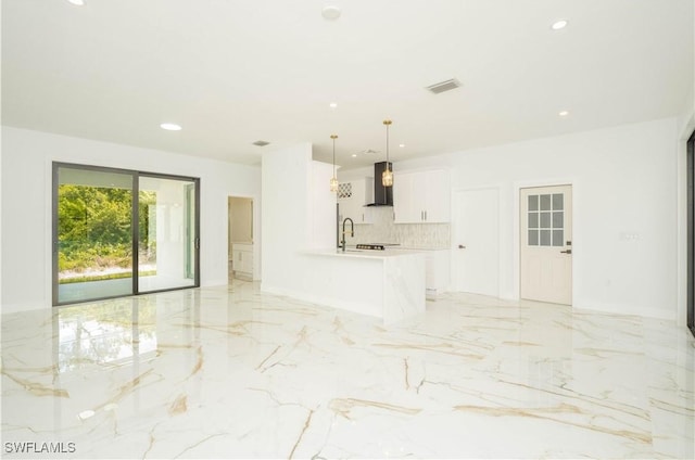 1603 E 5th St, Lehigh Acres, FL 33972 - unfurnished living room featuring light marble finish flooring, recessed lighting, and a sink