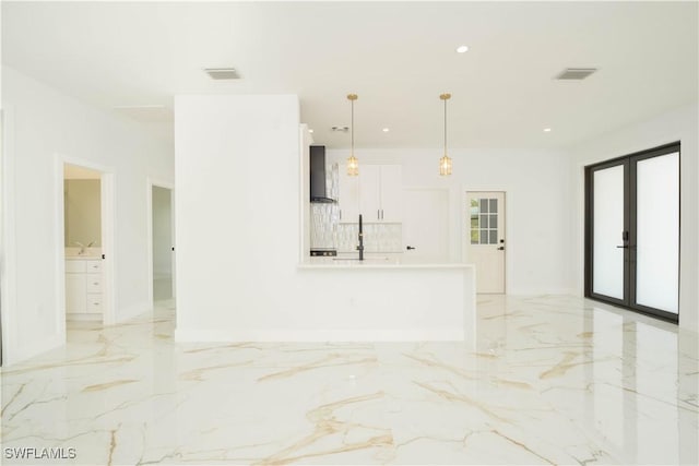 1603 E 5th St, Lehigh Acres, FL 33972 - unfurnished living room featuring light marble finish flooring, french doors, recessed lighting, a sink, and baseboards