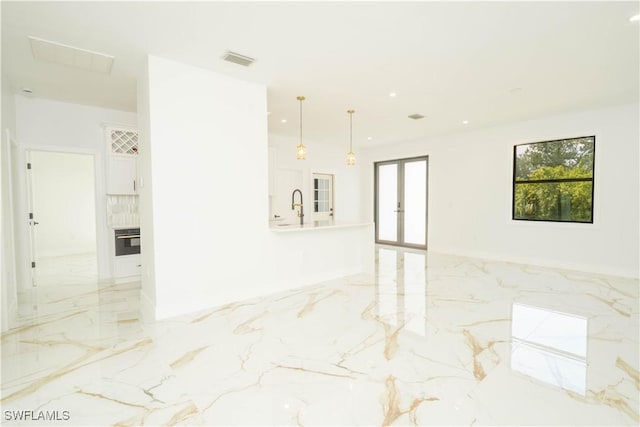 1603 E 5th St, Lehigh Acres, FL 33972 - empty room featuring light marble finish flooring, a sink, french doors, and recessed lighting
