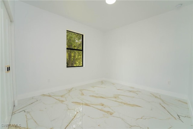 1603 E 5th St, Lehigh Acres, FL 33972 - spare room featuring marble tiled floors, baseboards, and a smoke detector
