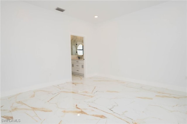 1603 E 5th St, Lehigh Acres, FL 33972 - empty room featuring light marble finish floors, baseboards, and recessed lighting